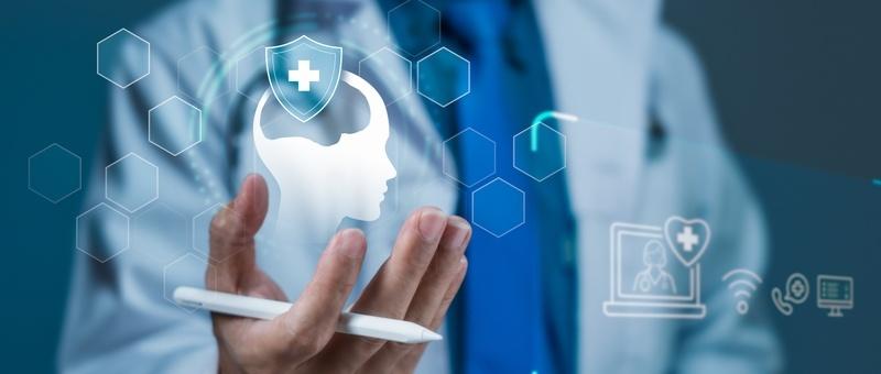 Healthcare professional holding smartphone with digital mental health icon and medical technology symbols.