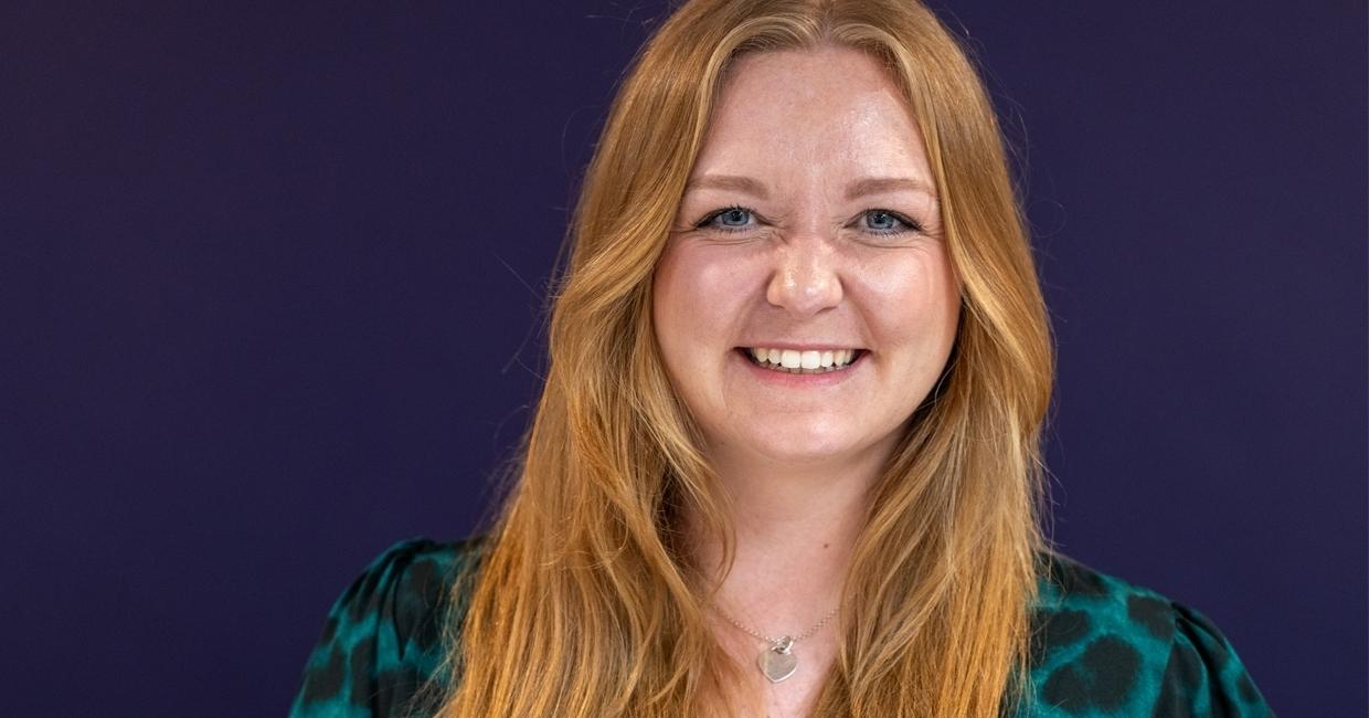 Hannah Shore, Head of Sleep Science, Mattress Online, and former Sleep Researcher at Silentnight. White female with honey blonde hair in green and black patterned clothing, wearing silver heart necklace.