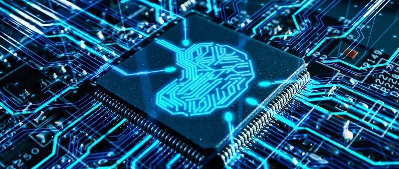 Computer chip with glowing blue brain-shaped circuit pattern on dark circuit board background.