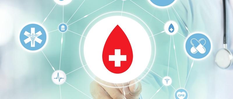 Red blood drop with white cross surrounded by medical icons and connected network, with healthcare professional background.